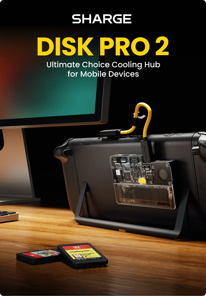Transparent SHARGE Disk Pro 2 hub attached to a handheld gaming device beside SD cards